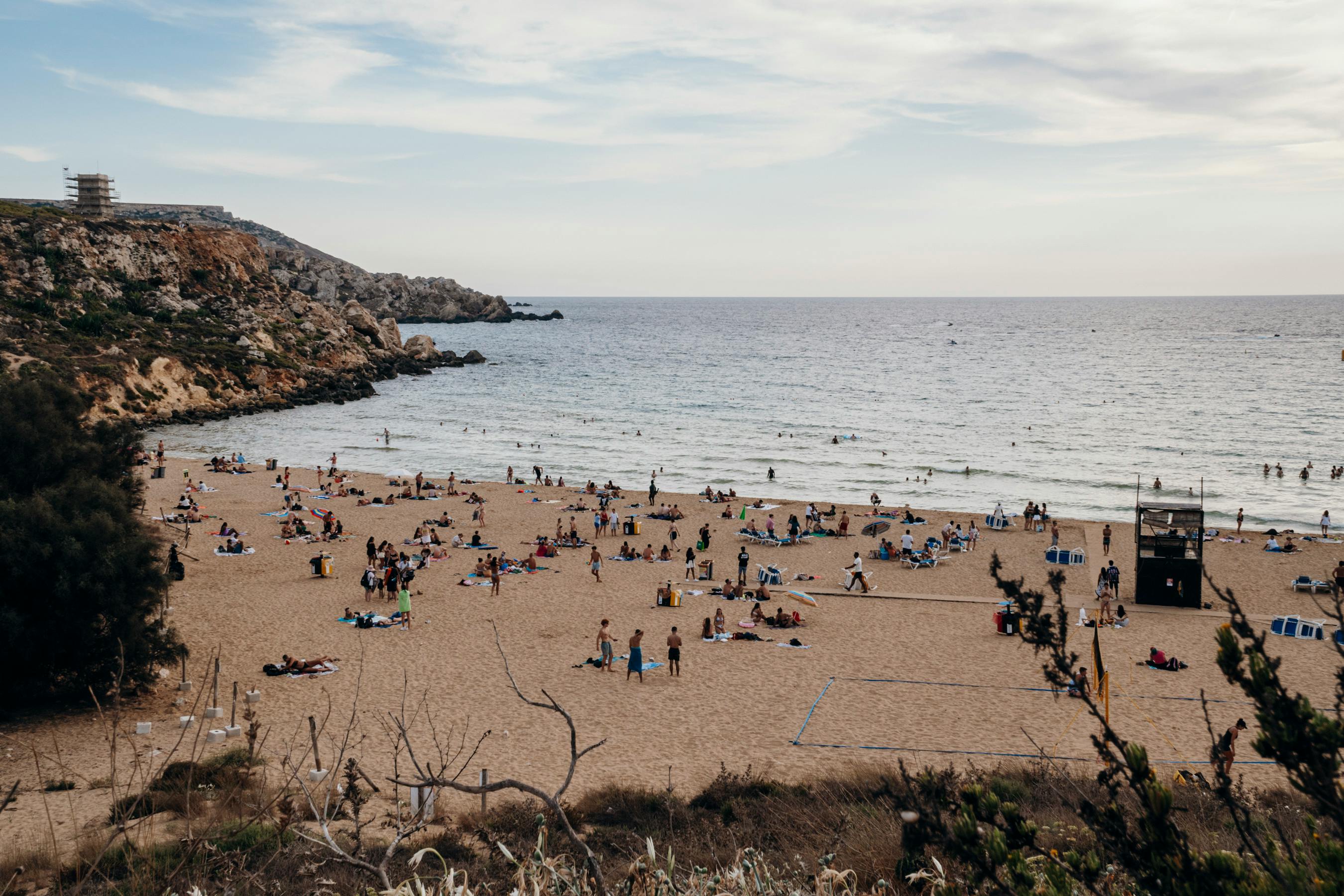 Sandy beach with students enjoying the Mediterranean