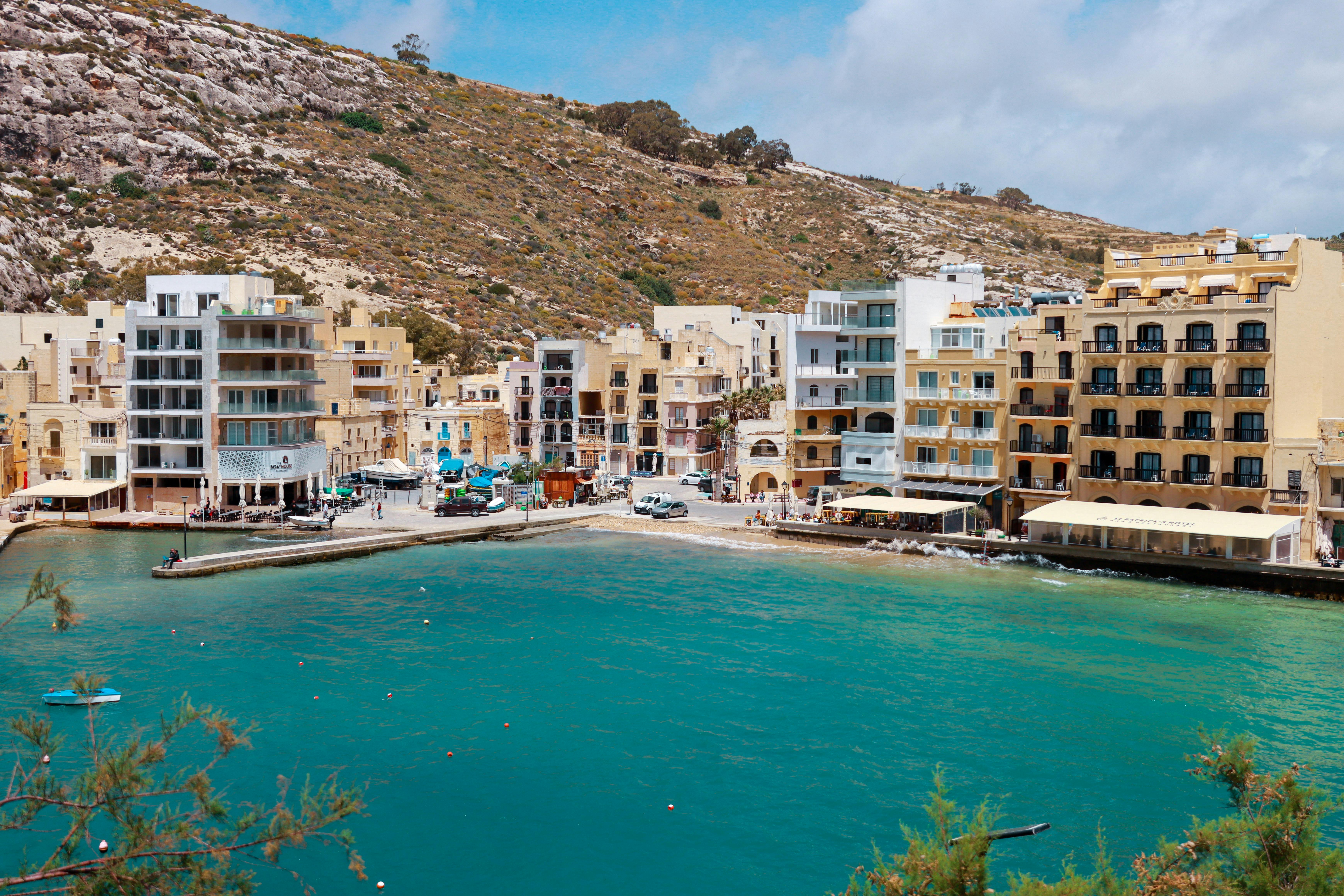 Xlendi Bay in Gozo — turquoise water and limestone buildings
